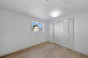 Interior space with a closet and light hardwood / wood-style floors