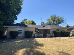 Single story home with a front lawn