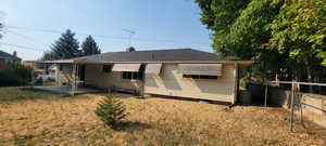 Back of property featuring a lawn and a patio area