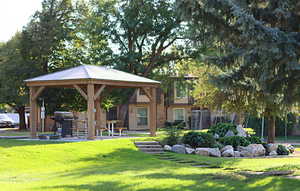 View of community featuring a lawn and a gazebo