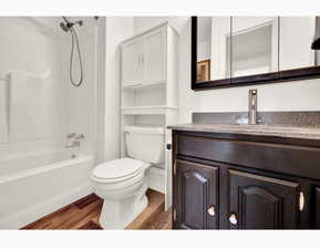 Full bathroom featuring vanity, toilet, shower / bathing tub combination.