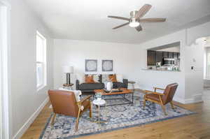 Living room featuring wood-type flooring and ceiling fan