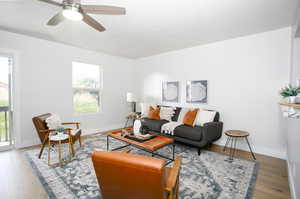 Living room featuring hardwood / wood-style floors and ceiling fan