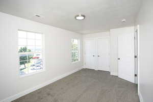 Unfurnished bedroom with carpet flooring