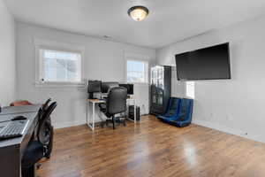 Office space with a healthy amount of sunlight and wood-type flooring