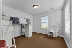 Carpeted bedroom featuring a textured ceiling