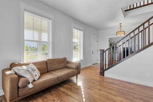 Living room with a healthy amount of sunlight and light hardwood / wood-style flooring