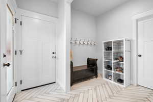 Mudroom with light parquet flooring