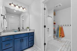 Bathroom with vanity and  shower combination