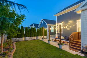 Yard at dusk featuring a patio