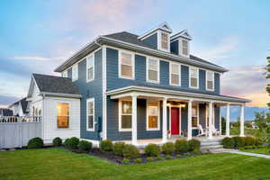 View of front of home featuring a porch and a yard