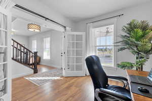 Office area with a wealth of natural light and hardwood / wood-style floors