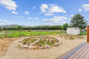 View of yard featuring a mountain view, a rural view, and a chicken coop