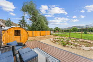 Exterior space with yard, sauna, deck and a mountain view