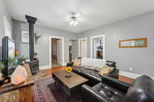 Living room featuring a wood stove and light wood-type flooring