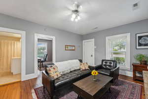 Living room featuring ceiling fan and dark hardwood / wood-style floors