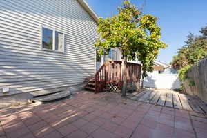 Deck and patio outside the kitchen and dining area with fruit trees