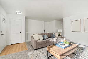 Living room with light hardwood / wood-style floors