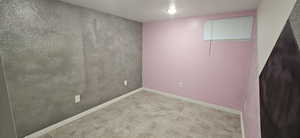 Unfurnished room with a textured ceiling