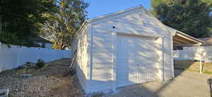 View of outdoor structure featuring a garage