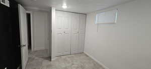 Unfurnished bedroom with a textured ceiling and a closet