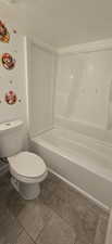 Bathroom with toilet and shower / washtub combination