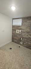 Laundry room featuring hookup for an electric dryer and a textured ceiling