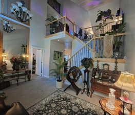 View of living, main bedroom, kitchen entry, and loft from right of entry door.