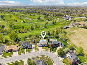 Drone / aerial view with golf course view and a residential view