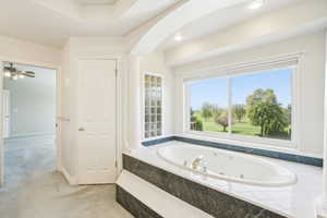 Full bathroom featuring a whirlpool tub and ornate columns