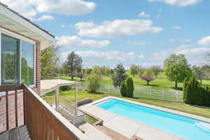 View of pool with a lawn, a fenced in pool, and a fenced backyard