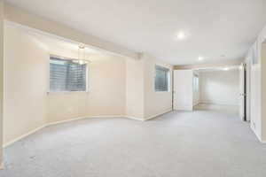 Basement with light carpet, baseboards, and recessed lighting