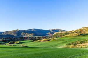 View of home's community with a mountain view and a yard