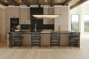 Kitchen featuring beam ceiling, a kitchen breakfast bar, backsplash, black double oven, and light hardwood / wood-style floors