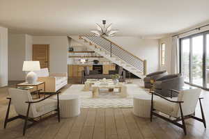 Living room with light hardwood / wood-style floors and a notable chandelier