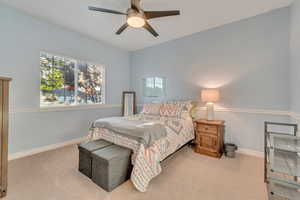 Bedroom featuring ceiling fan and carpet floors