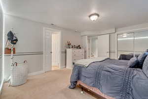 Bedroom featuring light colored carpet