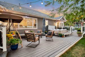 Deck at dusk featuring outdoor lounge area