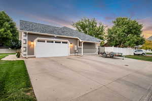 View of front facade with a garage and a yard