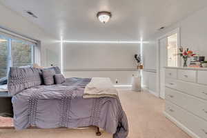 Bedroom with light colored carpet