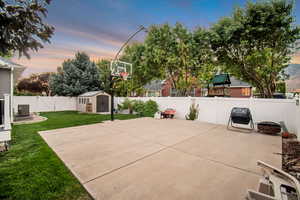 View of basketball court featuring a lawn