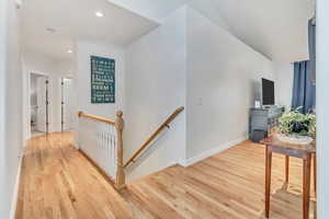 Hallway with light hardwood / wood-style floors