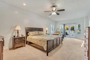 Carpeted bedroom featuring ceiling fan, access to exterior, and french doors