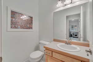 Bathroom with vanity, toilet, and tile patterned flooring