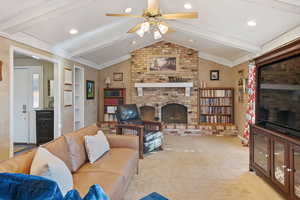 Beautiful brick fireplace with vaulted and beamed ceiling.