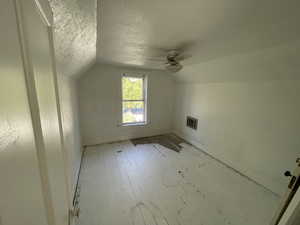 Additional living space featuring lofted ceiling, ceiling fan, and light hardwood / wood-style floors