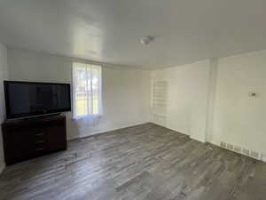 Unfurnished living room with hardwood / wood-style floors