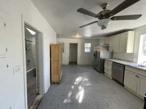 Kitchen featuring ceiling fan, a textured ceiling, appliances with stainless steel finishes, and sink