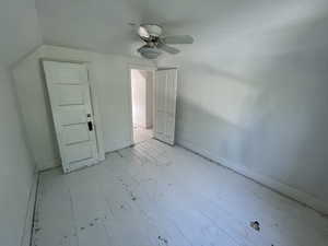 Additional living space featuring light wood-type flooring, vaulted ceiling, and ceiling fan