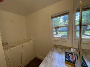 Washroom featuring a textured ceiling and hardwood / wood-style floors